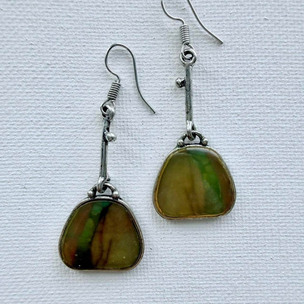 Green and yellow swirly glass earrings set in textured silver